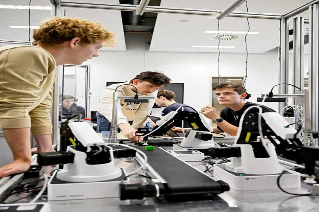 Mechanical engineering students working on a robotics and automation project in an engineering laboratory