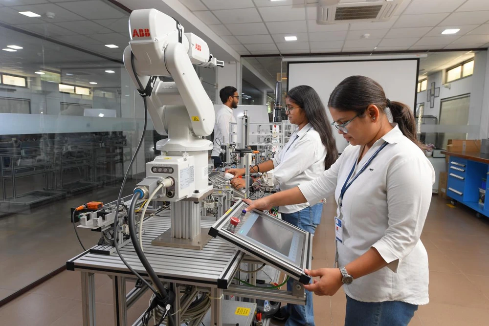 Mechanical engineering students learning robotics and industrial automation